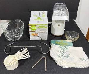 lot 129 image: Kitchenware Collection with Glass Measuring Cup, Pressure Cooker Steamer, Popcorn Maker, and Utensils