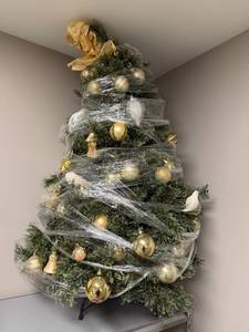 lot 210 image: Table Top Decorated Artificial Christmas Tree with Ornaments and Bow Topper - wrapped for storage