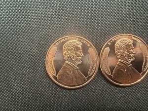lot 99 image: Two Copper 1 Oz Rounds Lincoln Design