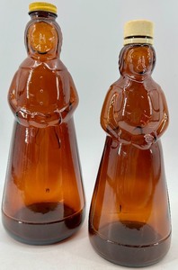 lot 57 image: Mrs Butterworth Syrup Bottles - Vintage Amber Glass - QTY 2