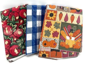 lot 243 image: Outdoor Padded Plastic Tablecloths - Apple Print, Blue Plaid, Patchwork Pumpkin (Lot of 3)