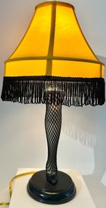 lot 49 image: Leg Lamp from A Christmas Story - Yellow Shade with Black Fringe & Fishnet Leg
