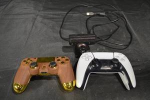 lot 62 image: PlayStation DualSense Controllers - WhiteBlack & Wood Grain Gold Finish & USB Webcam