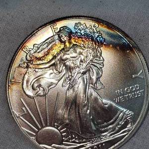 lot 86 image: 2011 Silver Eagle $1, Beautiful Rainbow Toning, BU