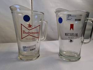 lot 115 image: Vintage Budweiser and Michelob glass beer pitchers featuring classic breweriana branding.