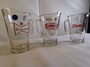lot 119 image: Three vintage-style beer pitchers from different breweries incliding Budweiser King of Beers glass pitcher