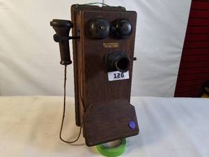 lot 126 image: Antique Western Electric oak cased wall-mounted crank telephone, commonly used in the early 20th century