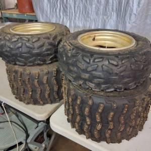 lot 308 image: Set of used ATV tires mounted on gold-colored rims