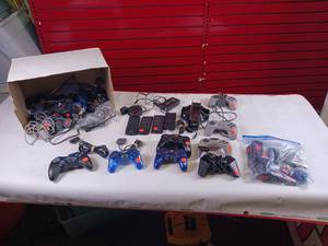 lot 220 image: Collection of vintage video game accessories and plug-and-play consoles including PlayStation 2 and PlayStation 1 controllers