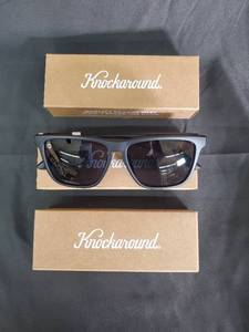 lot 125 image: Knockaround Sunglasses - Black Frame with Blue Pouch