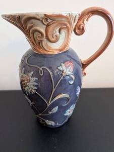 lot 225 image: Vintage Embossed Floral Ceramic Pitcher with Scroll Handle