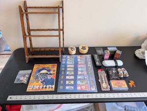 lot 254 image: World Travel Collectibles Lot Including Iraqi Coins, Foreign Currency, Spoons, Figurines, and Wooden Display Rack