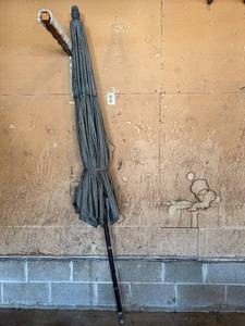 lot 439 image: Patio Umbrella - Black Canopy, Folded, Outdoor Shade