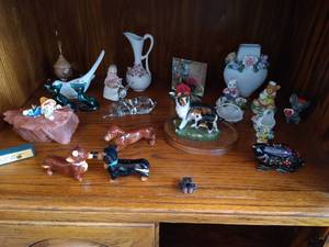 lot 33 image: Bottom Shelf of Figurines - Kissing Dachshund S&P Shakers, Deer, Dogs, Etc...