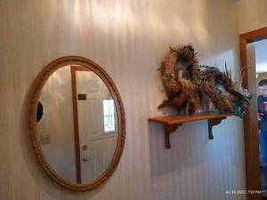 lot 88 image: 27 Framed Oval Mirror, Wooden Shelf, and (2) Feathered Wreaths