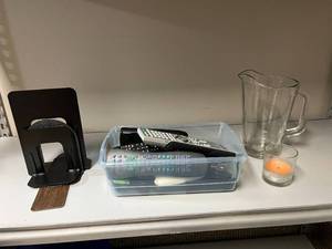 lot 91 image: Mixed Home and Office Accessories Lot with Remotes, Bookends, Pitcher, and Candle