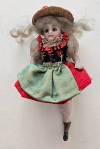 lot 104 image: Antique Bisque Miniature Doll - Red & Green Dress & Straw Hat