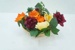lot 69 image: Silk Rose Vine and Woven Basket