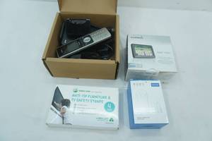 lot 250 image: Garmin (new), anti-tip furniture & TV Safety Straps (new), Securi door chime (new), Verizon Base & Wireless Handset (phone & router)