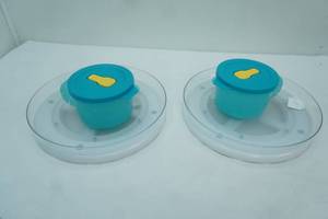 lot 337 image: 2 Turntable Organizers, 2 Tupperware Soup Mugs with Lids