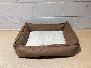 lot 136 image: Boots & Barkley Cuddler Faux Leather Bolster Dog Bed - M 28 Inches (L), 7 Inches (H) x 23 Inches (W)