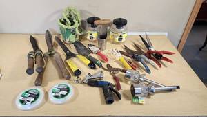 Various Garden Tools and Accessories including Trimmer Line, Shears, and Garden Hose