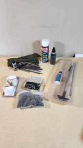Gun cleaning supplies including Ballistol, Break-Free CLP, rods, and patches, plus assorted hardware pieces and tools