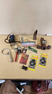 Various Automotive Accessories and Tools including Hitch Ball Mount, Tire Gauge, and Air Fresheners
