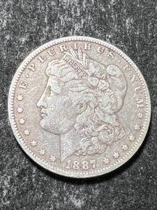 lot 21 image: 1887-O US MORGAN SILVER DOLLAR