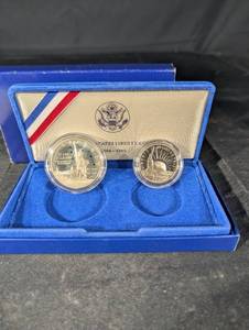 lot 68 image: United States Liberty Coins 1986 - Ellis Island Silver Dollar & Statue of Liberty Half Dollar (Lot of 2)