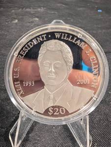 lot 222 image: Liberia 20 Dollars Clinton Commemorative Coin - William J. Clinton Portrait (1993-2001) 20g .999 Silver