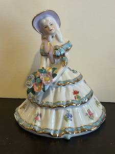 lot 144C image: LL - 7-Inch Porcelain Figurine - Woman in Tiered Floral Dress With Bouquet