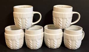 lot 249 image: Vintage Caribou Coffee White Embossed Knit Cup Cozy Mugs