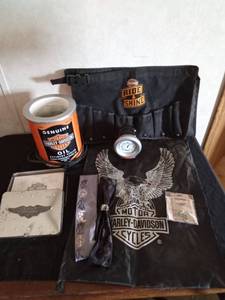 lot 63 image: Harley Davidson items Ring, lamp, tool bucket belt, stationary set in tin, helmet bag headbands and a motorcycle angel pin