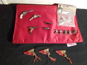 lot 142 image: 3 Miniature metal guns, 3 miniature metal guns in holsters with gems on butt of guns and 1975 custom cast metal historical figures