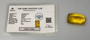lot 102 image: OM Gems Testing Lab Natural Topaz 80.25 Cts. Chusion Shaped Yellow Topaz (With Card)