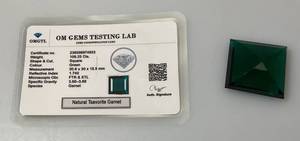 lot 103 image: OM Gems Testing Lab Natural Tsavorite Garnet 109.25 Cts. Square Shaped Green Garnet (With Card)