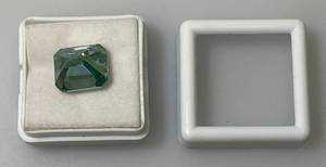 lot 118 image: 7.85 Ct. Lab Created VVS1 VividBlue Emerald Cut Massonite Gemstone (In Protective Case)