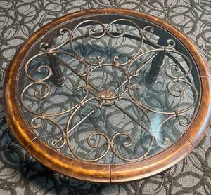 lot 71 image: Round Glass Coffee Table - Wrought Iron Scrollwork & Wood Rim