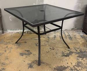 lot 969 image: Glass Top Patio Table - Black Metal Frame