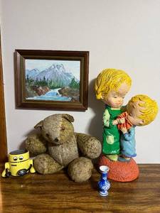 lot 148 image: ROBBIE Yellow Robot Toy, Kissing Figurine, Vintage Teddy Bear, Framed Mountain Painting, BlueWhite Vase Pair