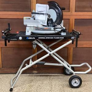 lot 5 image: Delta 12 Compound Laser Miter Saw Model 36-322L and Delta Universal Miter Sw Stand Model 36-136