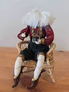 lot 147 image: Santa Claus Sitting on a Wicker Chair Figurine by Band Creations
