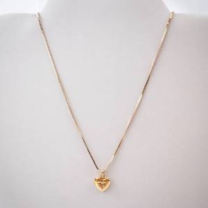 Gold-Tone Engraved Cross Heart Locket Necklace.