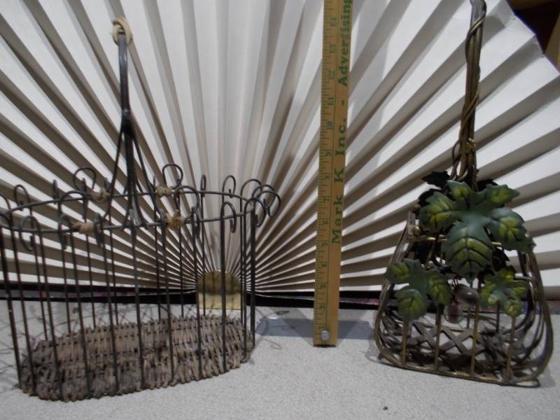 lot 21 image: The image shows two vintage metal baskets,