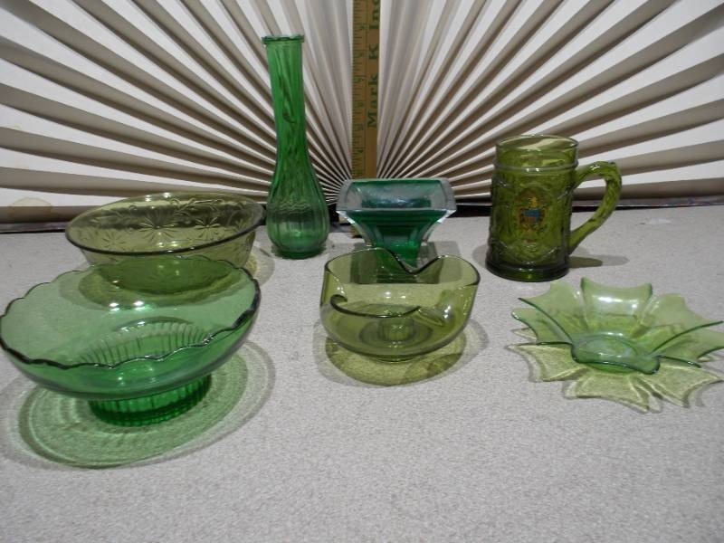 lot 31 image: This collection features various vintage green glass items, likely from the Mid-Century Modern (1950s-1970s) or Depression glass (1920s-1940s) eras.