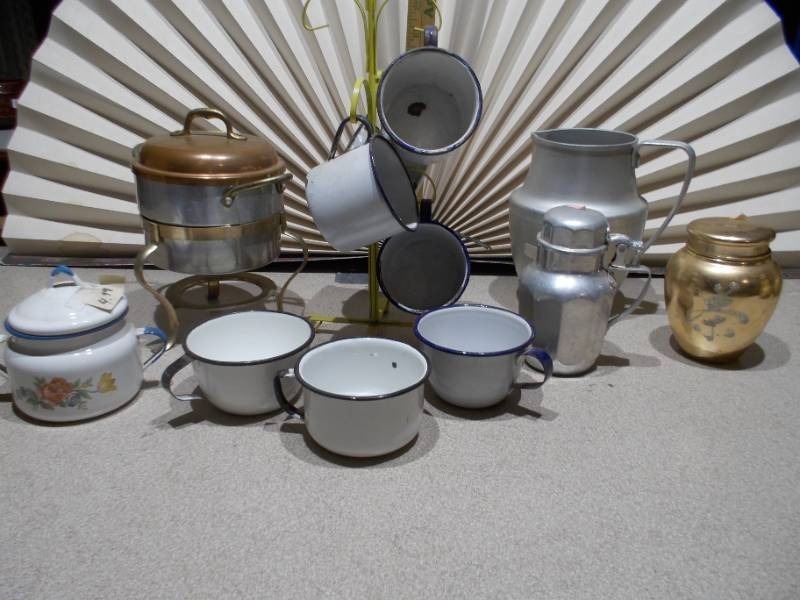 lot 32 image: The image displays a collection of vintage enamelware and aluminum kitchen items, primarily used for serving beverages.