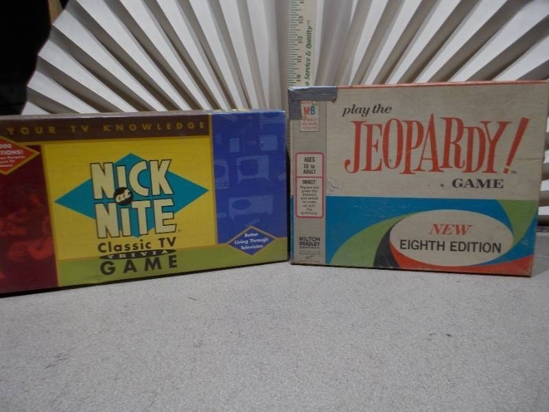 lot 83 image: The image shows two vintage board games the Nick at Nite Classic TV Trivia Game and the Jeopardy Game.
