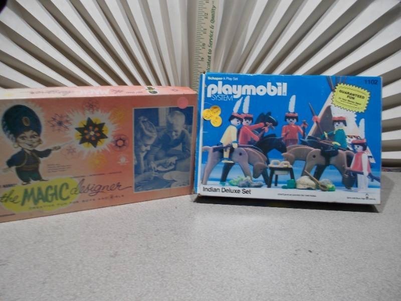 lot 84 image: The image features two vintage toys the Playmobil System Indian Deluxe Set #1102 and a toy called the MAGIC designer