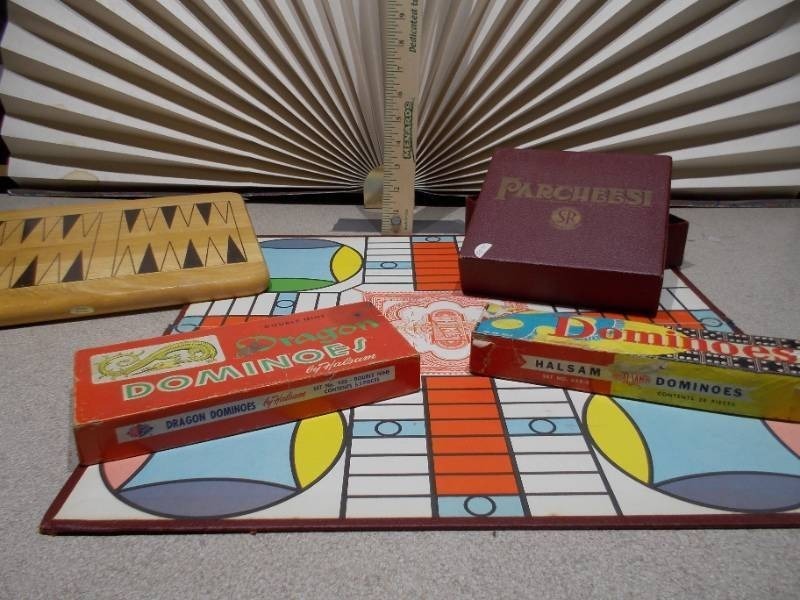 lot 85 image: The image displays a collection of vintage board games, including a Parcheesi board and boxes, a backgammon board, and two boxes of HALSAM Dragon Dominos
